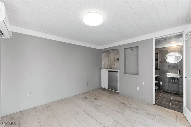 a view of a kitchen with a sink and a refrigerator