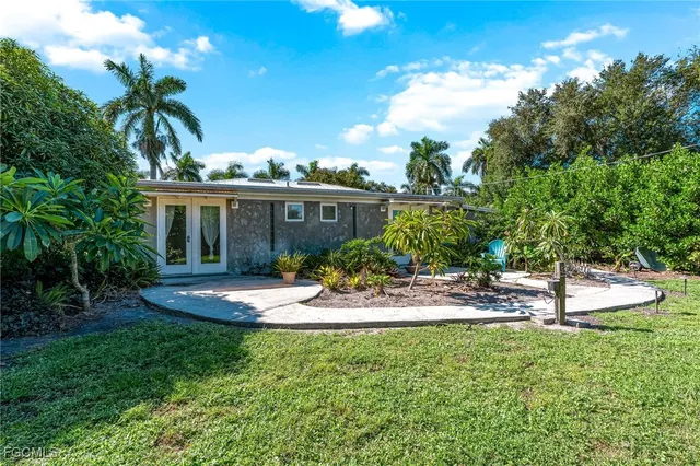 a view of a house with a yard and sitting area