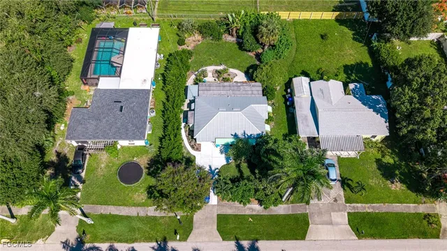 an aerial view of a house with yard swimming pool and outdoor seating
