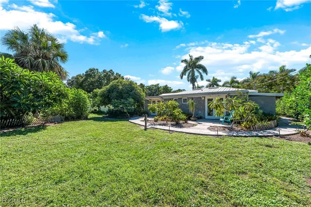 a view of a backyard with sitting area