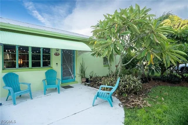 a view of house with backyard and outdoor seating