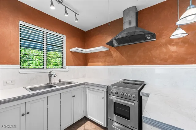 a kitchen with a stove and a sink