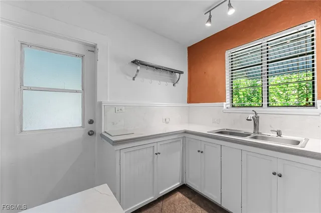 a kitchen with a sink and cabinets