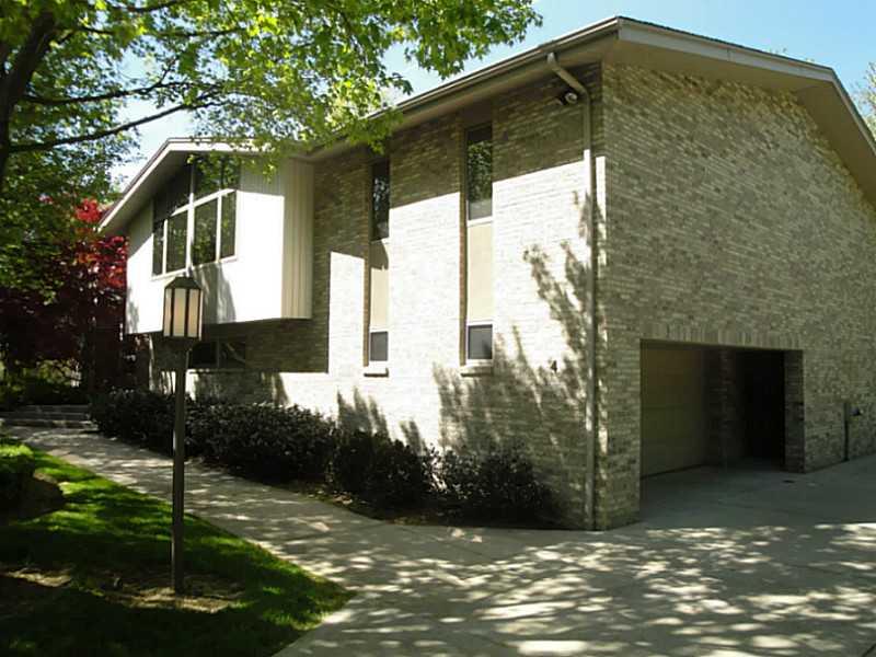 4 Elmhurst Road Green Tree, PA 15220 - Photo 2 of 25 Exterior Front. A view of the side facade of the home showing the two-car integral garage. Additional parking is available in the wide driveway. The walkway ending in a small set of stairs leads to the front entry.