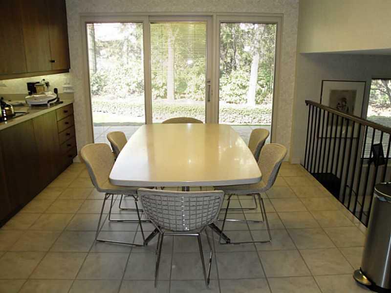 4 Elmhurst Road Green Tree, PA 15220 - Photo 11 of 25 Kitchen. The sunny eat-in area of the kitchen opens to one of two side patios. The family room is to the right of the space.