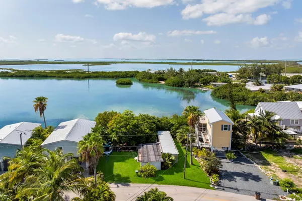 an aerial view of a house with a lake view