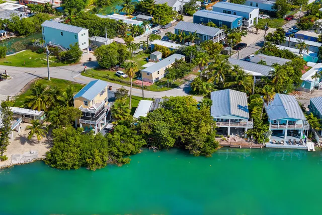 an aerial view of multiple houses with yard