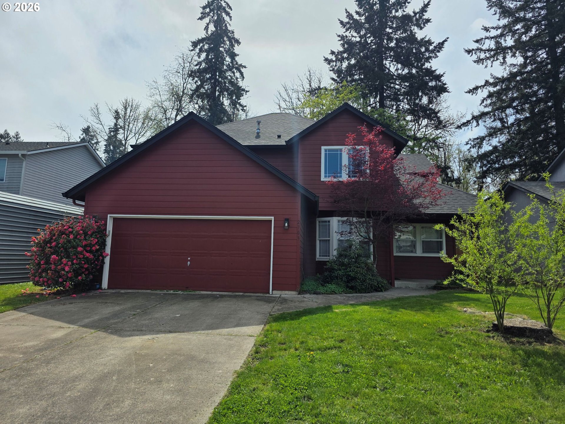 2703 Southwest 11th Street Battle Ground, WA 98604 - Photo 1 of 16 a front view of a house with a garden and yard
