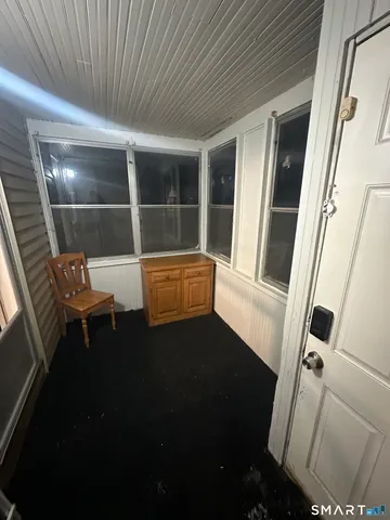 a view of chair and wooden door