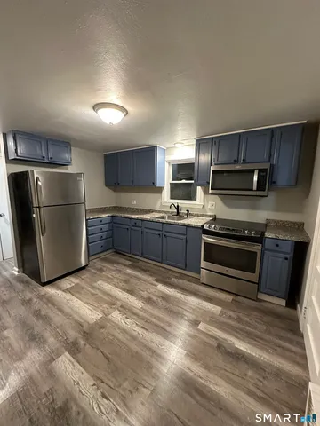 a kitchen with a refrigerator and a sink