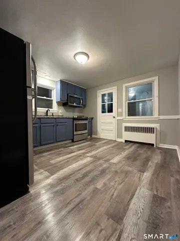a large kitchen with a refrigerator and a stove top oven