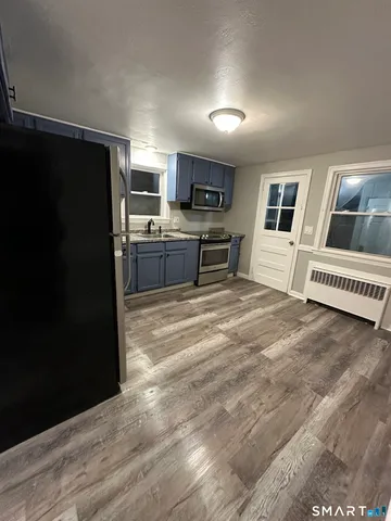 a kitchen with a refrigerator and a counter top space