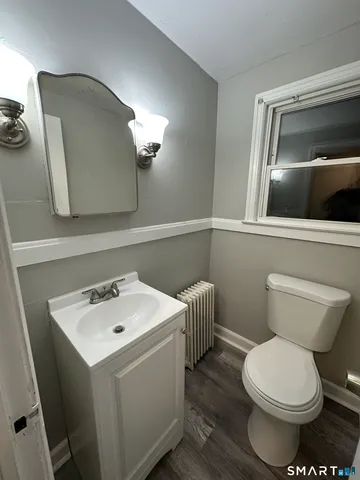 a bathroom with a sink a toilet and mirror