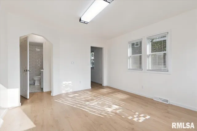 a view of empty room with windows