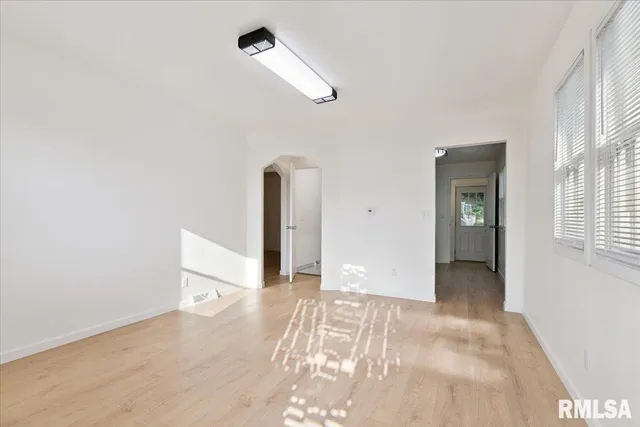 a kitchen with stainless steel appliances white cabinets and stove top oven
