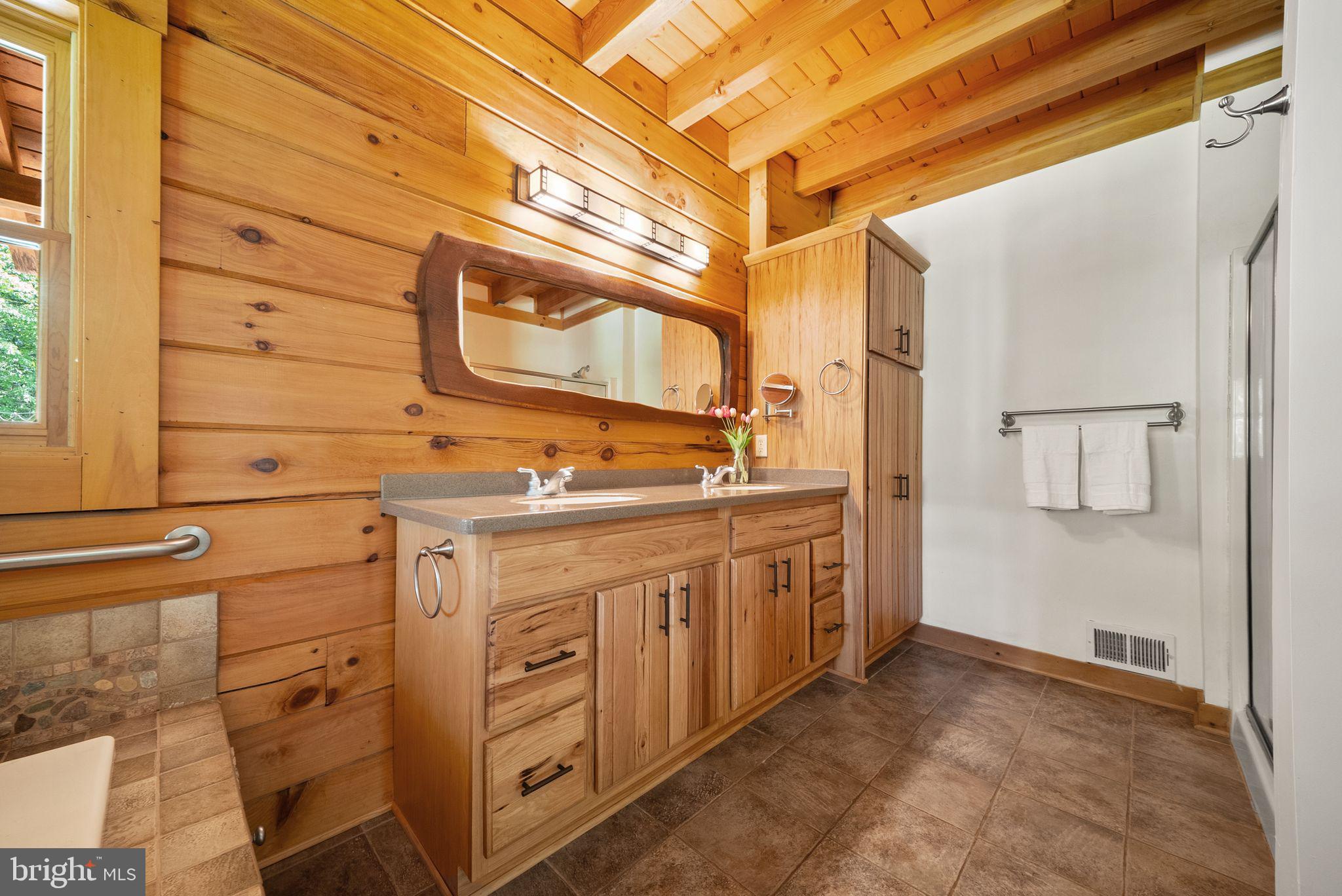 4020 Millwood Road Boyce, VA 22620 - Photo 37 of 132 Double vanity with warm log-home finishes.