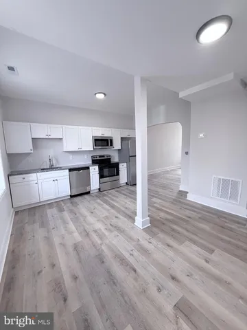 a view of kitchen and wooden floor