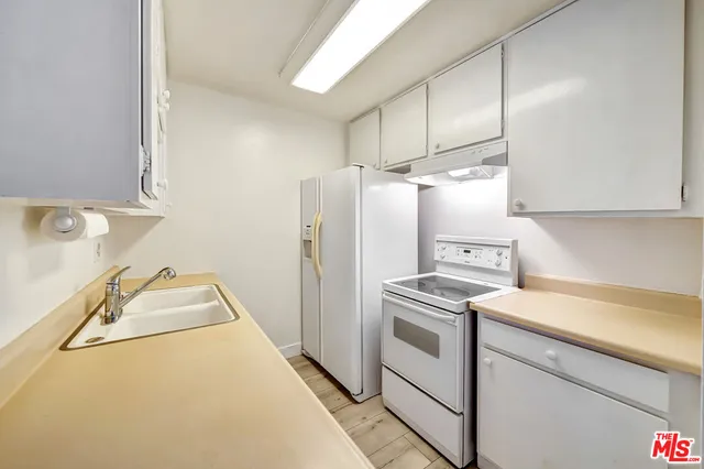a kitchen with a refrigerator sink and stove