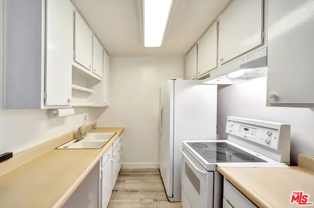 a kitchen with a sink a stove and refrigerator