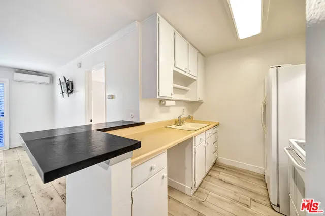a view of a kitchen with a sink stove and cabinets