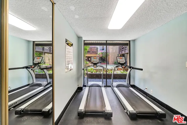 a large white kitchen with stainless steel appliances