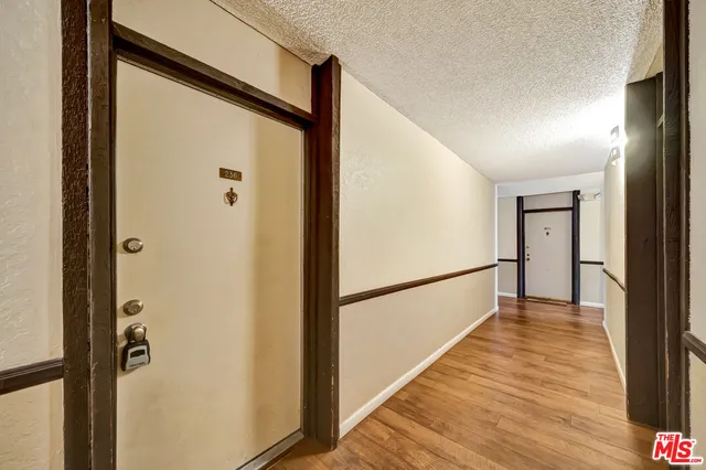 a view of a hallway with wooden floor