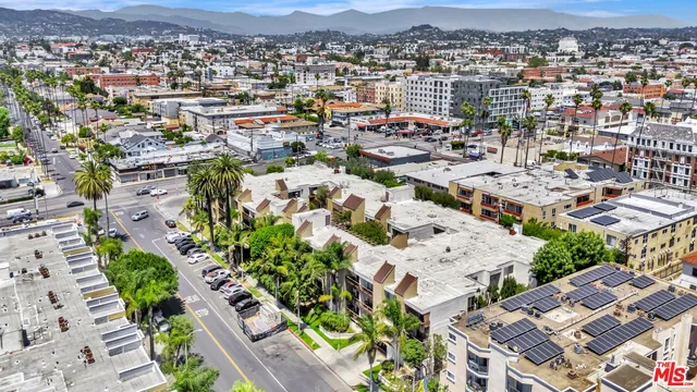 a front view of a house with a tree