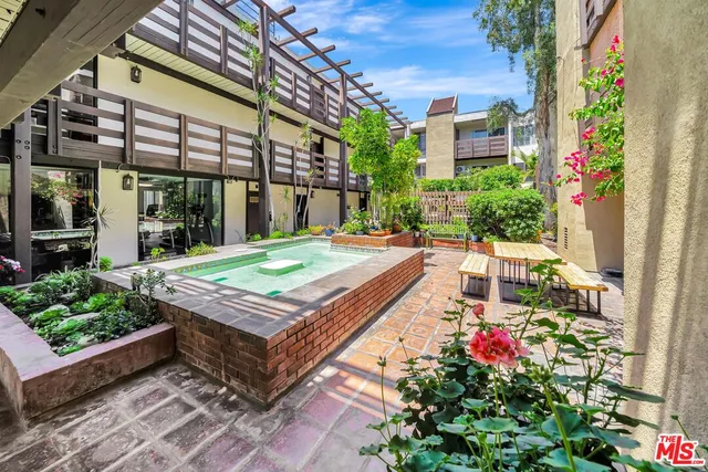 a living room with furniture and a book shelf