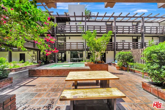 a view of a livingroom with furniture and floor to ceiling window