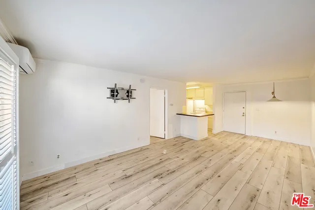 a view of a livingroom with wooden floor and window