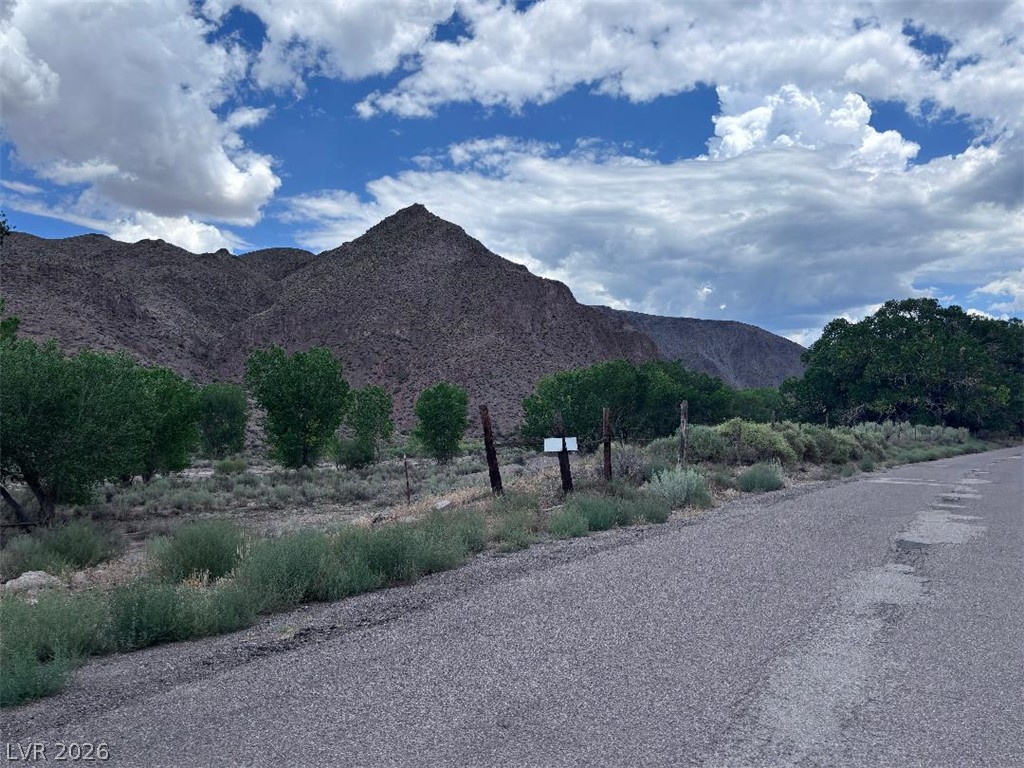 200 Clover Creek Road Caliente, NV 89008 - Photo 4 of 4 A tranquil road leads to commanding mountain vistas, framed by lush trees and natural landscaping.part of 55.9 acres.