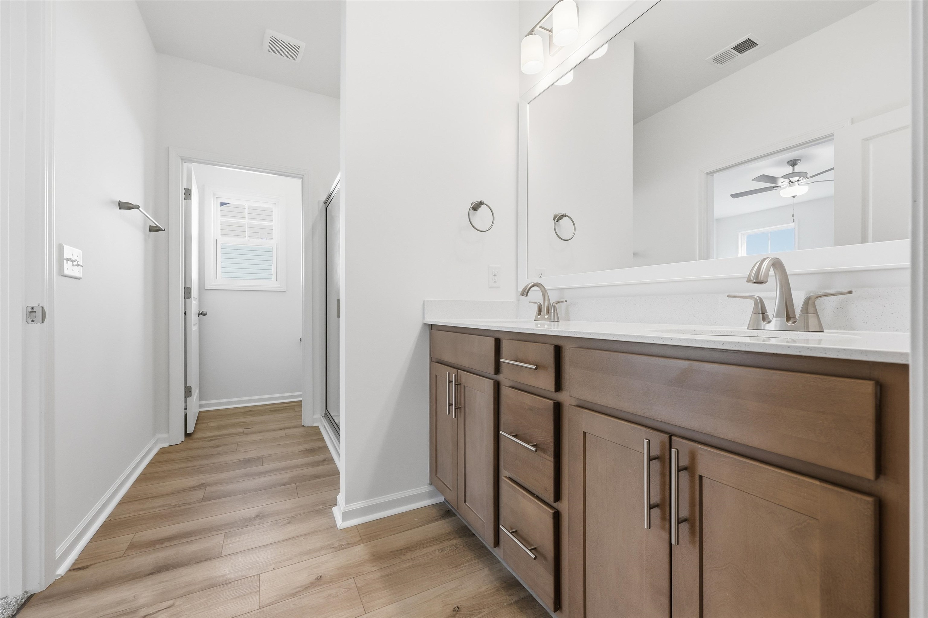 145 River Birch Drive Loris, SC 29569 - Photo 13 of 36 Full bath with double vanity, light wood-style floors, a shower stall, and healthy amount of natural light