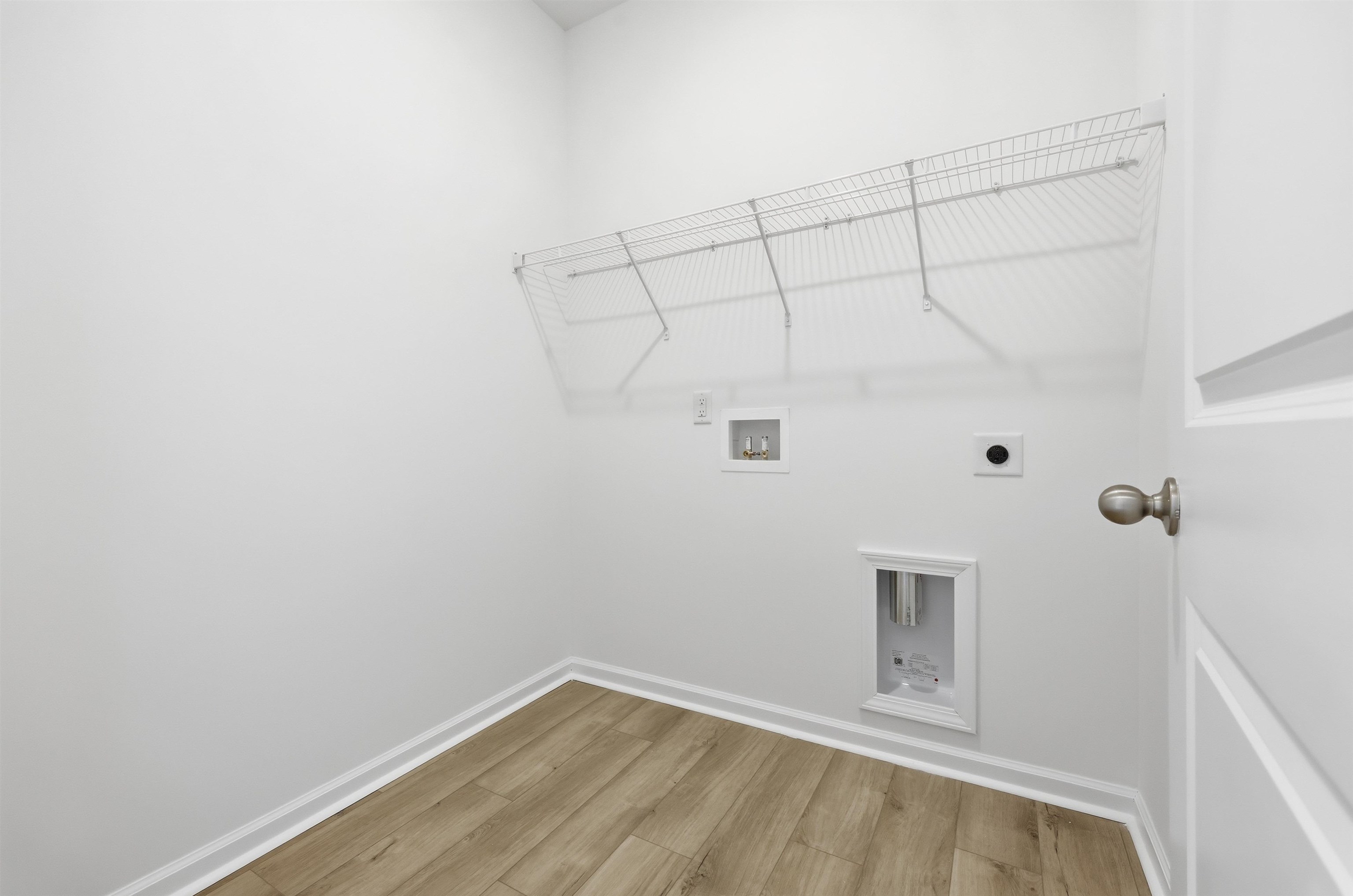 145 River Birch Drive Loris, SC 29569 - Photo 15 of 36 Washroom with light wood-type flooring, hookup for an electric dryer, and hookup for a washing machine