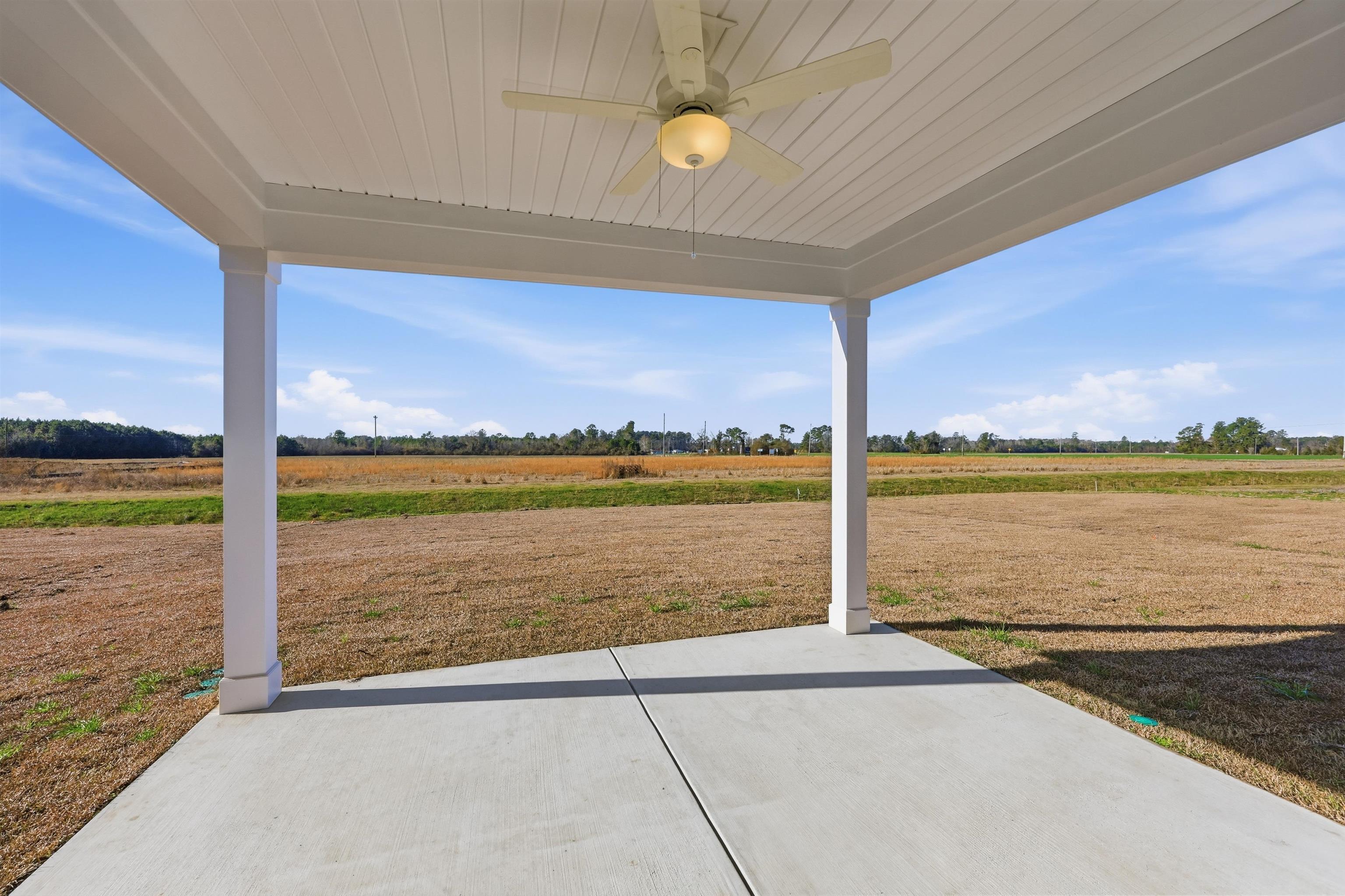 145 River Birch Drive Loris, SC 29569 - Photo 23 of 36 View of patio with ceiling fan and a view of countryside