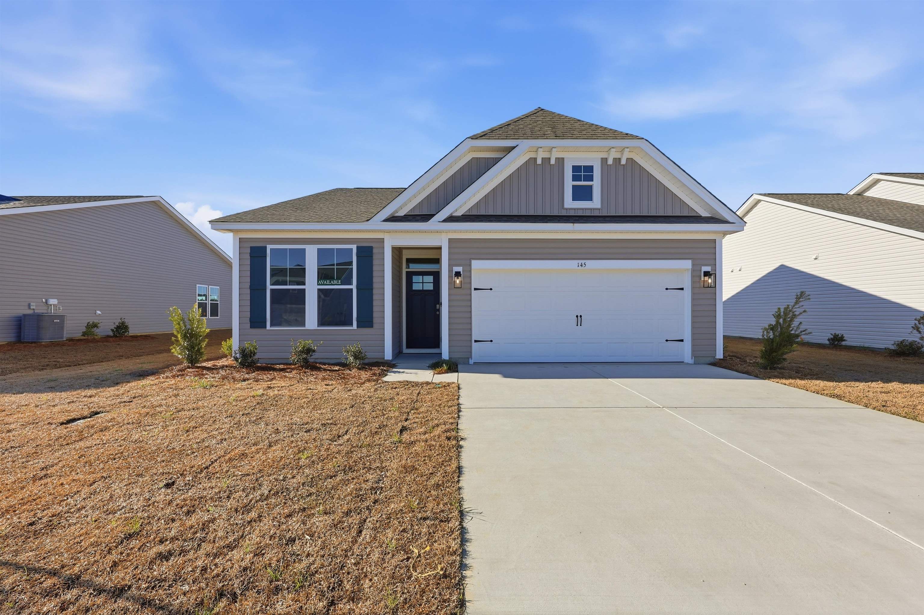 145 River Birch Drive Loris, SC 29569 - Photo 25 of 36 View of front of home with roof with shingles, driveway, board and batten siding, a garage, and a front yard