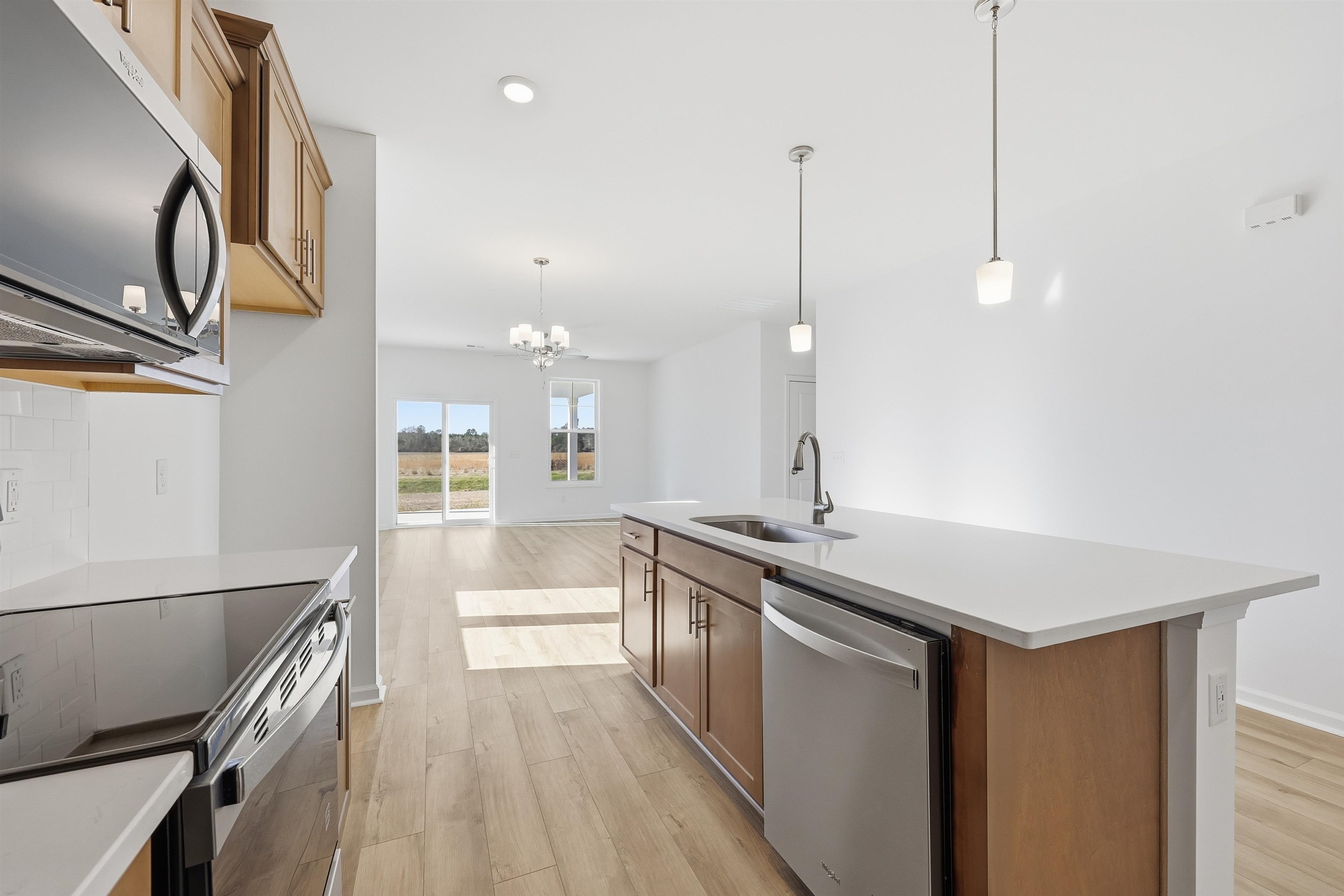 145 River Birch Drive Loris, SC 29569 - Photo 36 of 36 Kitchen with brown cabinetry, stainless steel appliances, open floor plan, light wood-style floors, and recessed lighting