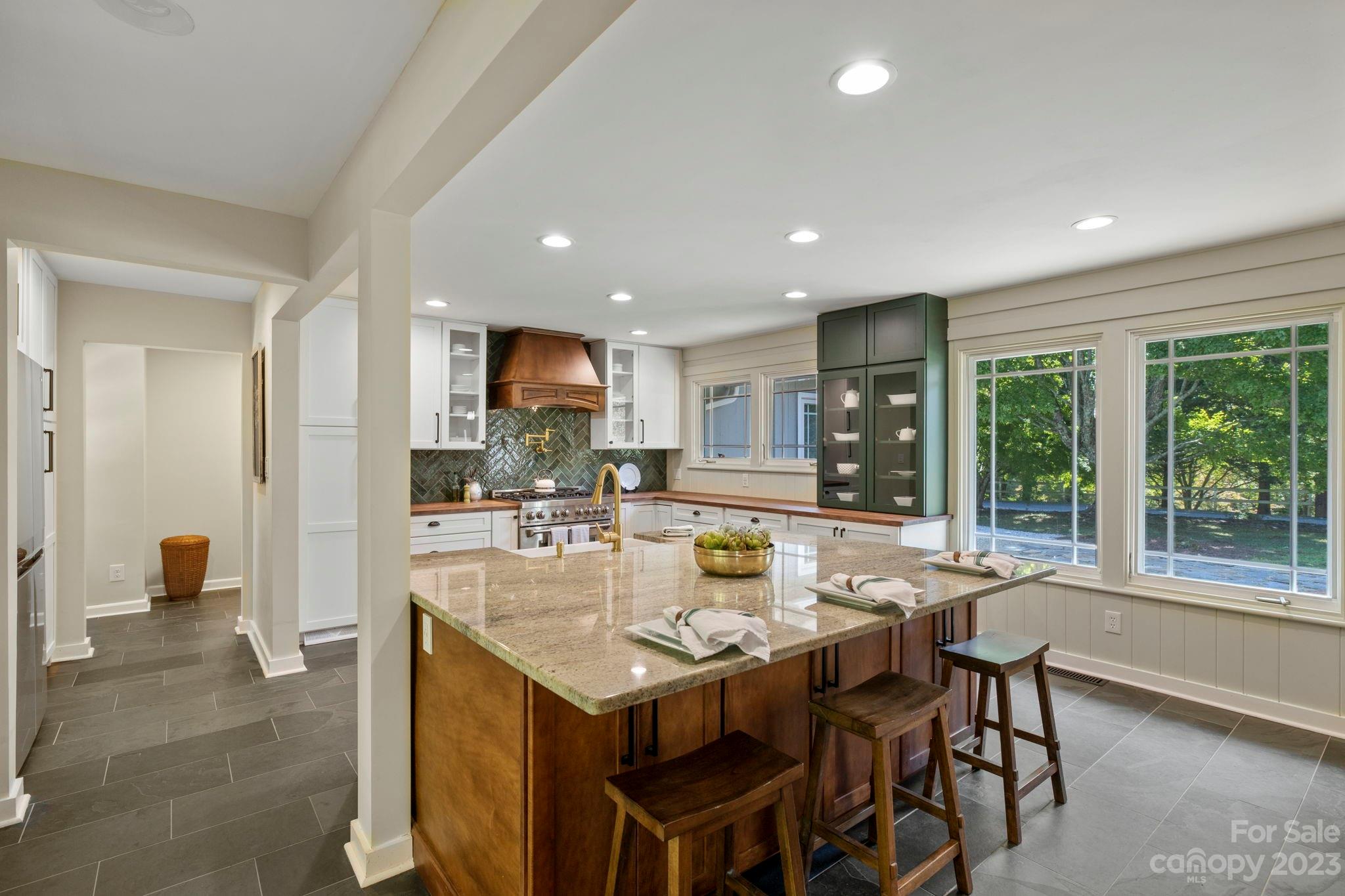 244 Mimosa Road Tryon, NC 28782 - Photo 3 of 47 a kitchen with a dining table chairs and refrigerator
