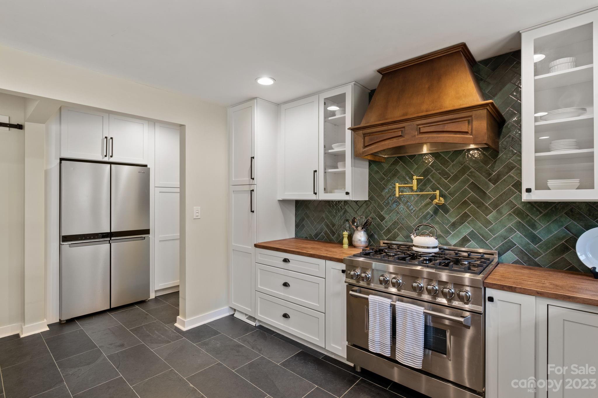 244 Mimosa Road Tryon, NC 28782 - Photo 8 of 47 a kitchen with a stove top oven and refrigerator