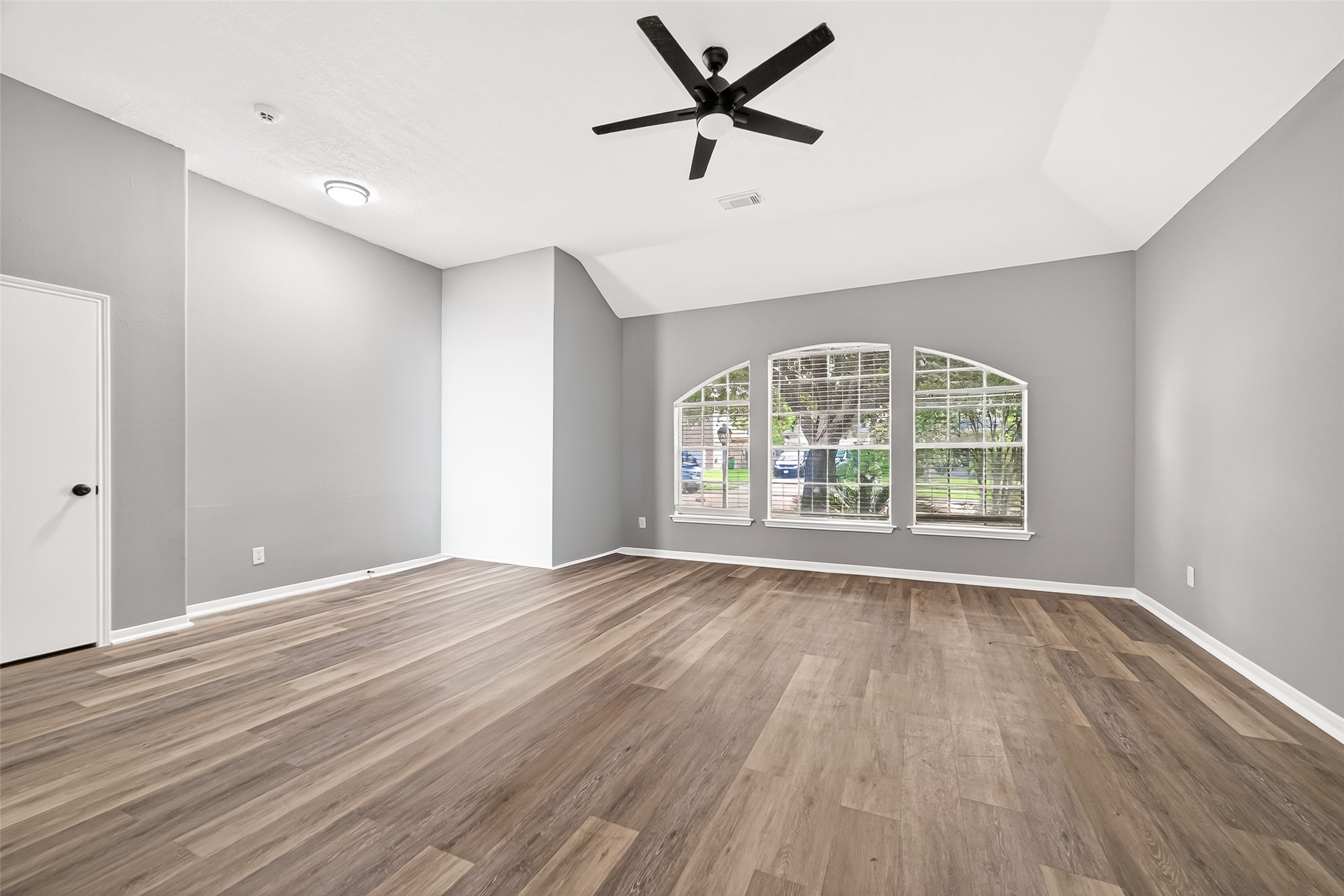 23810 Spring Way Drive Spring, TX 77373 - Photo 3 of 35 an empty room with wooden floor fan and windows
