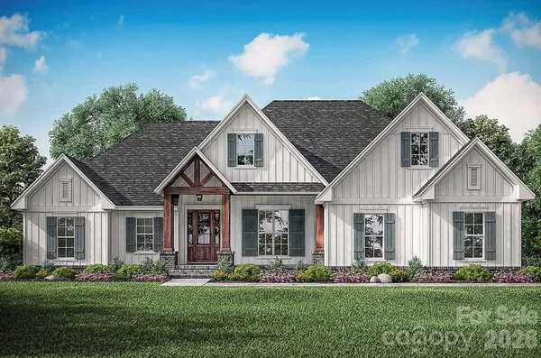 a front view of a house with a garden and plants