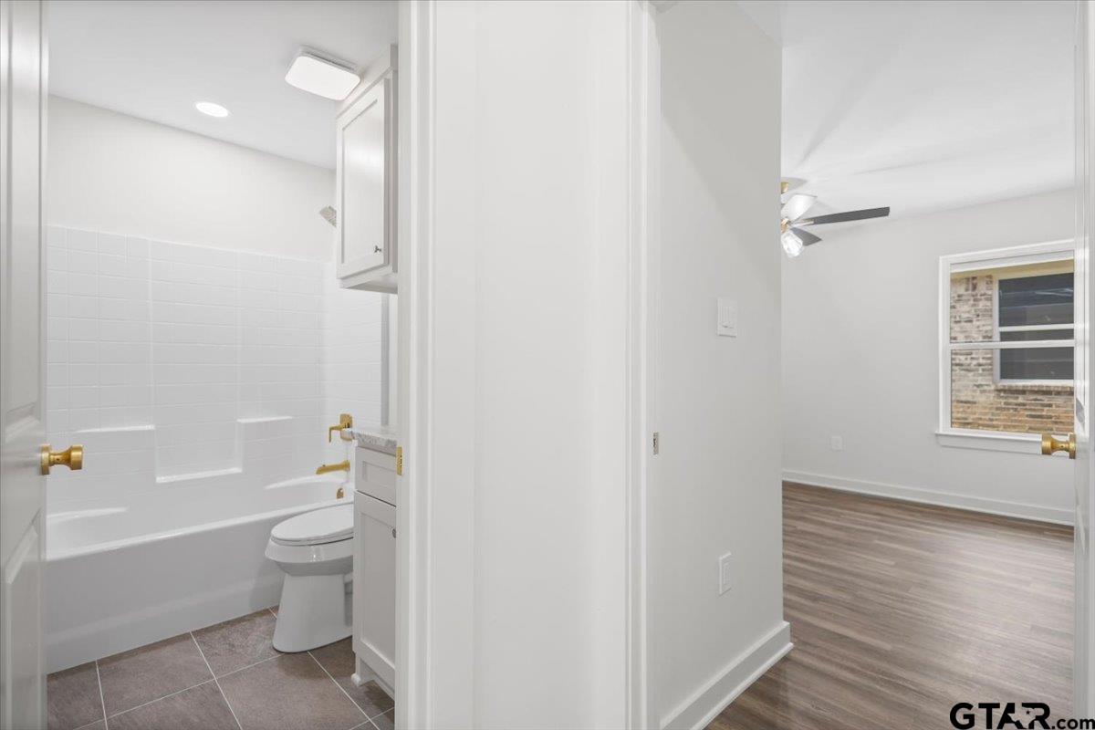 435 West Harmony Street Tyler, TX 75702 - Photo 11 of 22 a bathroom with a granite countertop toilet a sink and bathtub