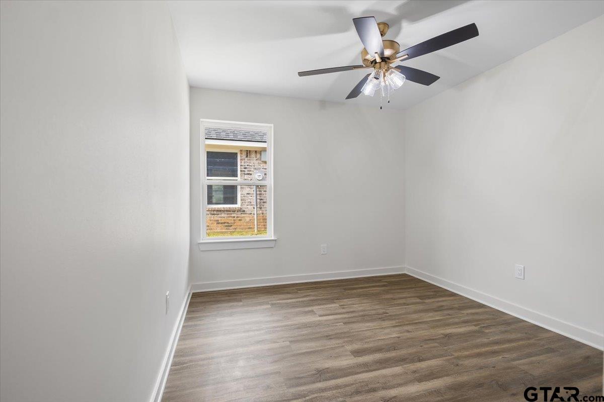 435 West Harmony Street Tyler, TX 75702 - Photo 17 of 22 wooden floor in an empty room with a window