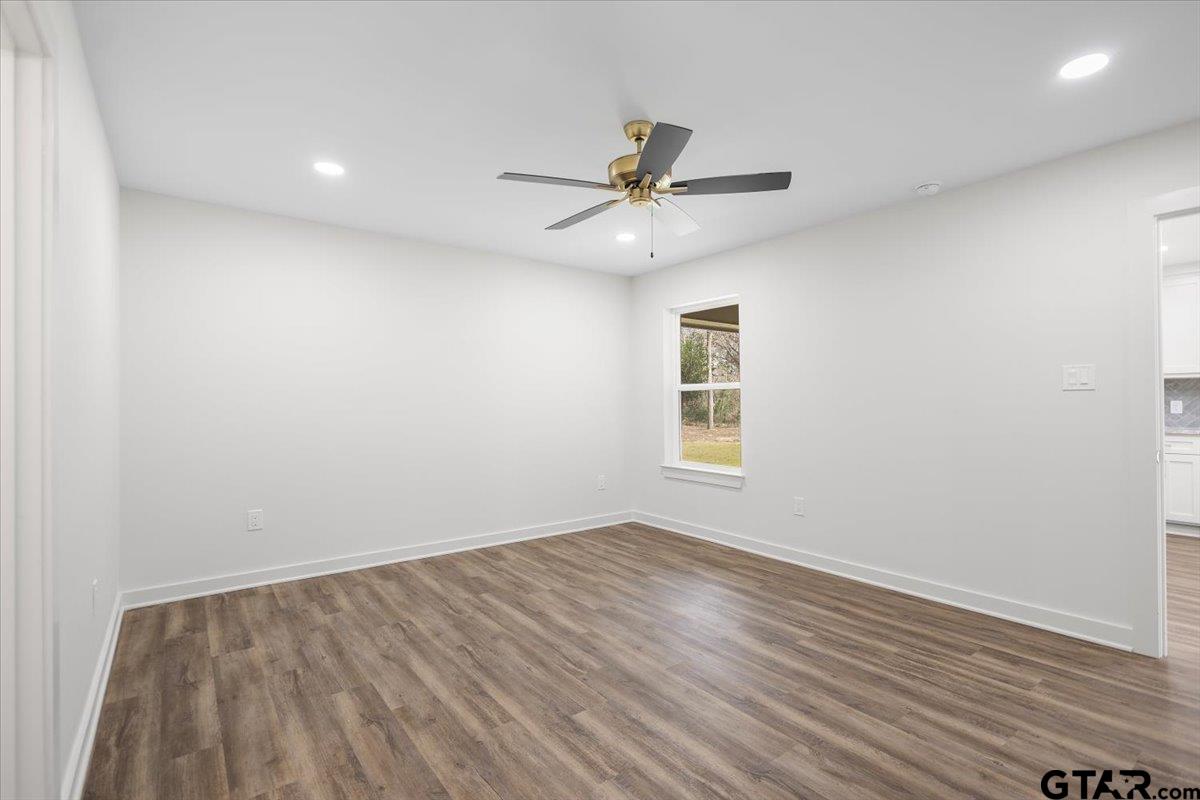 435 West Harmony Street Tyler, TX 75702 - Photo 20 of 22 wooden floor in an empty room with a window