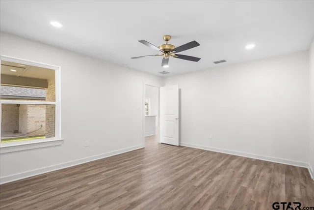 wooden floor in an empty room with a window
