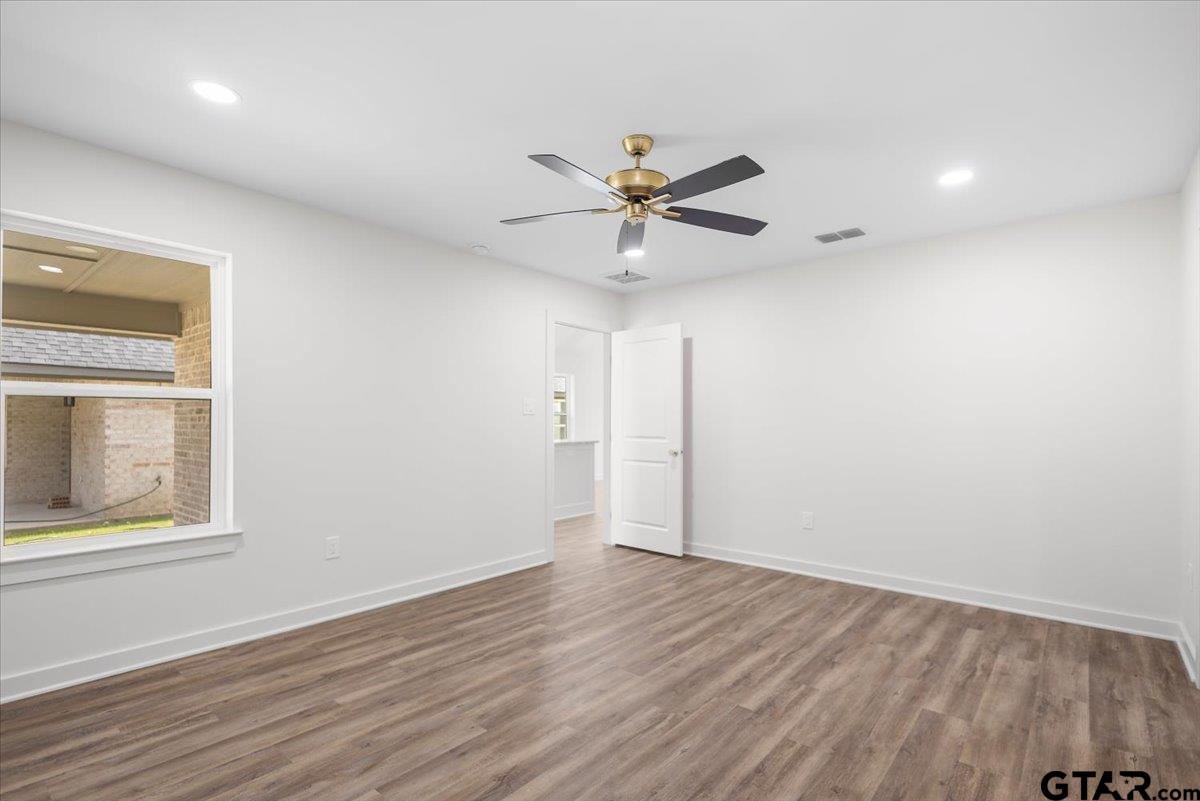 435 West Harmony Street Tyler, TX 75702 - Photo 21 of 22 wooden floor in an empty room with a window