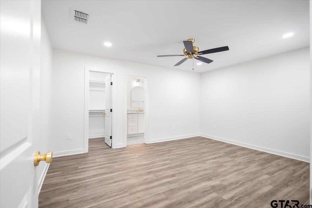 435 West Harmony Street Tyler, TX 75702 - Photo 8 of 22 wooden floor in an empty room with a window