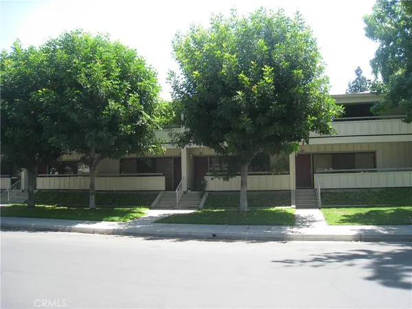 a house that has a tree in front of it