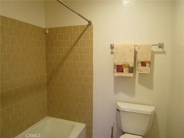 a bathroom with a shower and a toilet