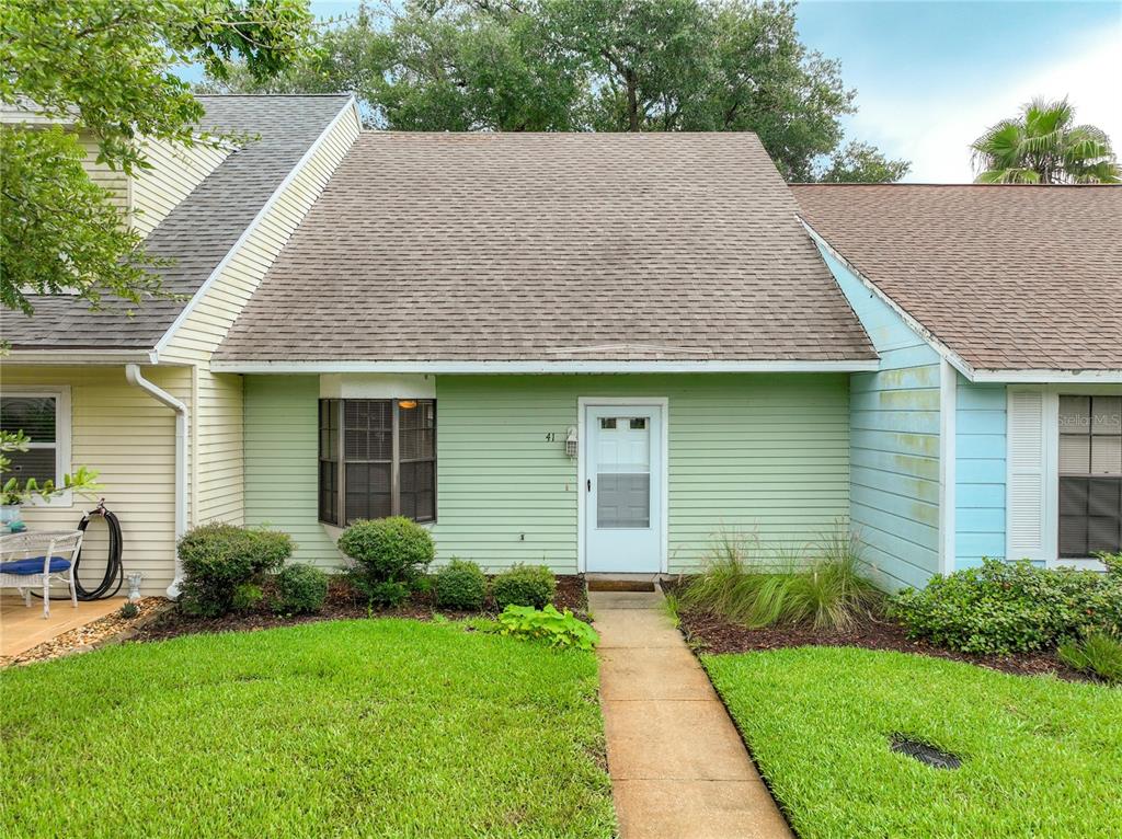 a aerial view of a house next to a yard
