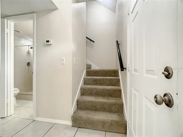 a view of staircase with white walls